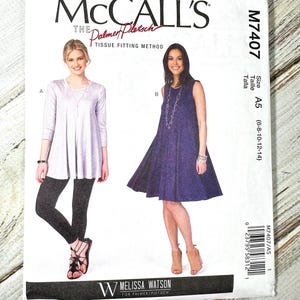 May include: McCall's sewing pattern M7407 featuring two women's fashion designs. The pattern includes a tunic and leggings, and a sleeveless dress. The pattern is size A5 (6-8-10-12-14). The brand is Melissa Watson for Palmer/Pletsch.