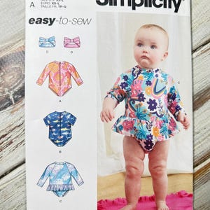 May include: Simplicity sewing pattern S9796 for baby swimwear. The pattern includes designs for a long-sleeve swimsuit with a ruffled skirt, a short-sleeve swimsuit, and a rash guard. The pattern is easy-to-sew and designed and printed in the USA.