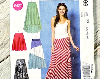May include: McCall's sewing pattern M6966 featuring skirt designs. The pattern includes various skirt styles, with a woman modeling a red and white striped maxi skirt. The package has the word "EASY" on it.