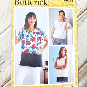 May include: A Butterick sewing pattern, B6214, showing three different top designs. The pattern includes a top with a floral print, a white top with a pocket, and a white top with a textured design. The size range is LRG-XLG-XXL.