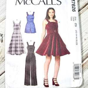May include: A McCall's sewing pattern, M7626, featuring illustrations of various women's garments. The designs include a dress, romper, and jumpsuit. The pattern is labeled with size D5, suitable for sizes 12-20.