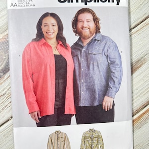 May include: Simplicity sewing pattern S9859 featuring two people wearing button-down shirts. The pattern includes shirt designs with stripes and floral prints. The text "easy-to-sew" is visible. The pattern is designed and printed in the USA.