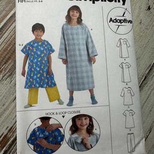 May include: Simplicity sewing pattern S9578 for children's adaptive clothing. The pattern includes instructions for a long-sleeved dress with a hook and loop closure, pants, and a short-sleeved shirt. The pattern is designed for sizes 3-6.