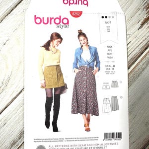 May include: A Burda Style sewing pattern packet, featuring images of women wearing skirts. The packet is white with the Burda Style logo and the number 6252. The text includes "ROCK, JUPE, SKIRT, FALDA" and size information.