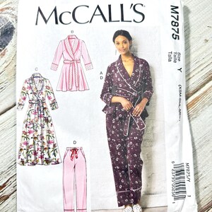 Może przedstawiać: Wzór szycia McCall's M7875 na piżamę i szlafrok. Wzór zawiera ilustracje szlafroka, spodni od piżamy i topu od piżamy. Główny obraz przedstawia kobietę w kwiecistym zestawie piżamowym. Wzór zawiera rozmiar Y (XSM-SML-MED).