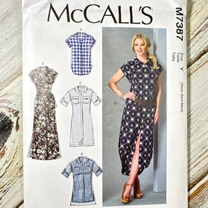 May include: A McCall's sewing pattern envelope featuring dress designs. The envelope displays various dress styles, including a short-sleeved gingham shirt, a striped shirt dress, and a patterned dress with a high slit. The text "McCall's" is prominently displayed.