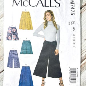 May include: McCall's sewing pattern M7475. The pattern features illustrations of various skirt and pants designs, including a yellow skirt, floral shorts, and denim skirt. The cover includes the text "McCALL'S" and size information.