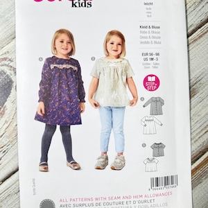 May include: A sewing pattern package featuring two children's dress and blouse designs. The package includes the "burda kids" logo, pattern number 9260, and size information. The designs include a long-sleeved dress and a short-sleeved blouse.