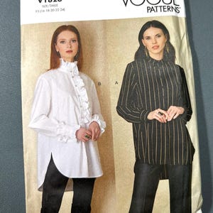 May include: Vogue Patterns sewing pattern V1823 featuring two blouse designs. One blouse is white with ruffles, the other is black with vertical stripes. The pattern includes sizes FS (16-18-20-22-24).