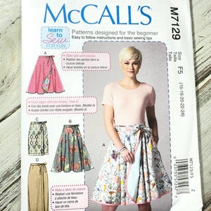 May include: McCall's sewing pattern M7129 for skirts. The pattern includes instructions for making side seam pockets and a fabric tie closure. The image shows a woman wearing a skirt made from the pattern, with a floral design.