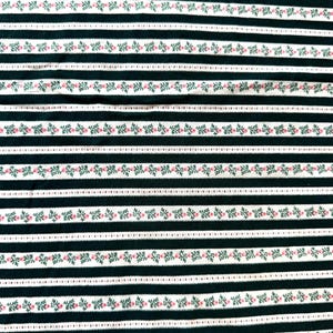 May include: Black and white striped fabric with a repeating pattern of green leaves and pink flowers.