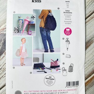 Skoltillbehör för barn. Ryggsäck med dragsko, sminkväska, pennväska, paraply, student. Pappersmönster Burda-stil. Ny oklippt 9256