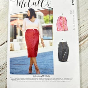 May include: McCall's sewing pattern M8149, featuring skirt designs. The cover shows a woman wearing a red skirt. Includes the text "#SterlingMcCalls" and size information. Designed and printed in the USA.