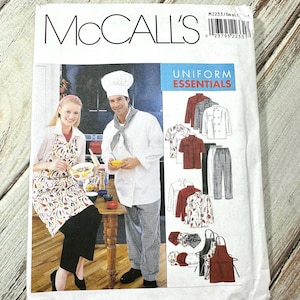 May include: McCall's sewing pattern for Uniform Essentials. The package shows a chef and a server, with illustrations of uniform items like shirts, trousers, aprons, and hats. The text "Uniform Essentials" is displayed. The pattern is for small sizes.