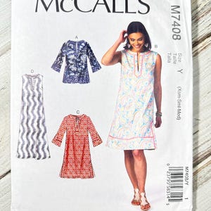 May include: A McCall's sewing pattern, M7408, featuring illustrations of various dress designs. The pattern includes a sleeveless dress with a paisley print, a long-sleeved dress with a geometric pattern, and other styles. The size is Y (Xsm-Sml-Med).