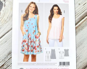 May include: A Burda Style sewing pattern packet, featuring a dress and top design. The front displays a light blue dress with a floral print and a pink top. The packet includes size information and the number 6532.