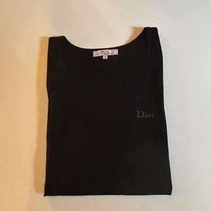 May include: Black t-shirt with a small embroidered "Dior" logo on the front.