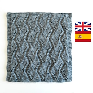 May include: A gray knitted square with a diamond pattern. The knit fabric has a textured, lacy look.