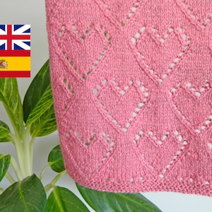 May include: A close-up of a pink knitted fabric with a diamond pattern and heart-shaped holes. The fabric is soft and delicate, and the pattern is intricate.