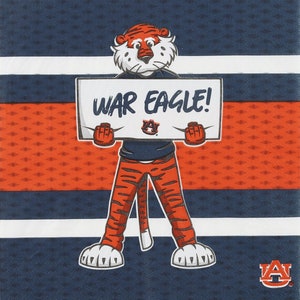 May include: A cartoon tiger wearing an orange and blue striped shirt and pants holds a sign that says "WAR EAGLE!" The tiger is standing on a blue and orange striped background with a white stripe in the middle. The tiger is wearing a blue shirt with a white "A" on it. The background is a blue and orange striped pattern.