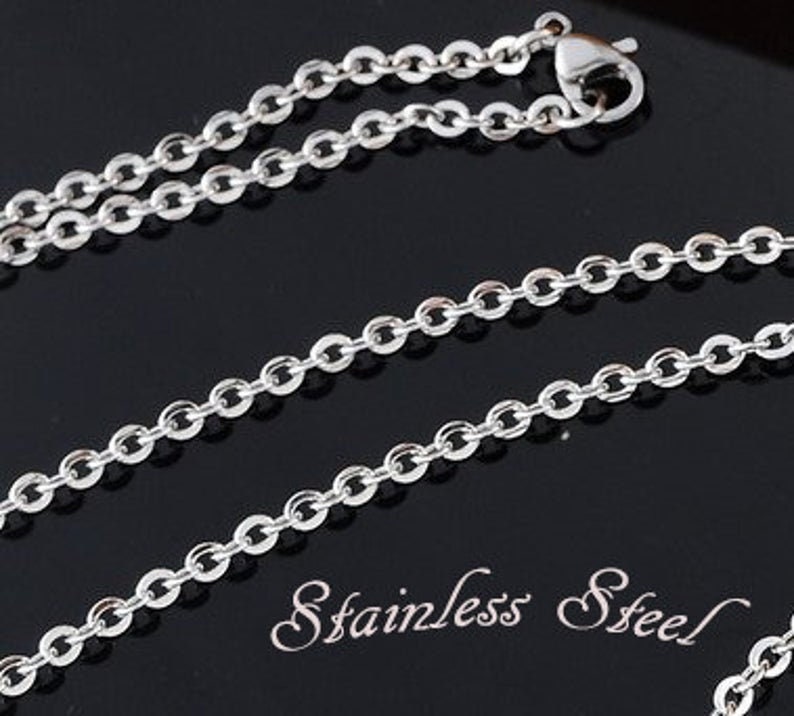 May include: A silver chain necklace made of stainless steel. The chain is a simple, classic design with oval links.
