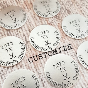May include: Silver metal round tokens with the text "2023 TX Gunslinger's Shootout" and a hockey stick graphic. The text "CUSTOMIZE" is superimposed on the image.