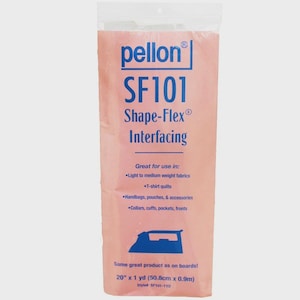 May include: Pink Pellon SF101 Shape-Flex interfacing in a clear plastic package. The package has blue text that reads "Shape-Flex Interfacing" and "Great for use in: light to medium weight fabrics, T-shirt quilts, handbags, pouches, & accessories". The package is 20" x 1 yd.
