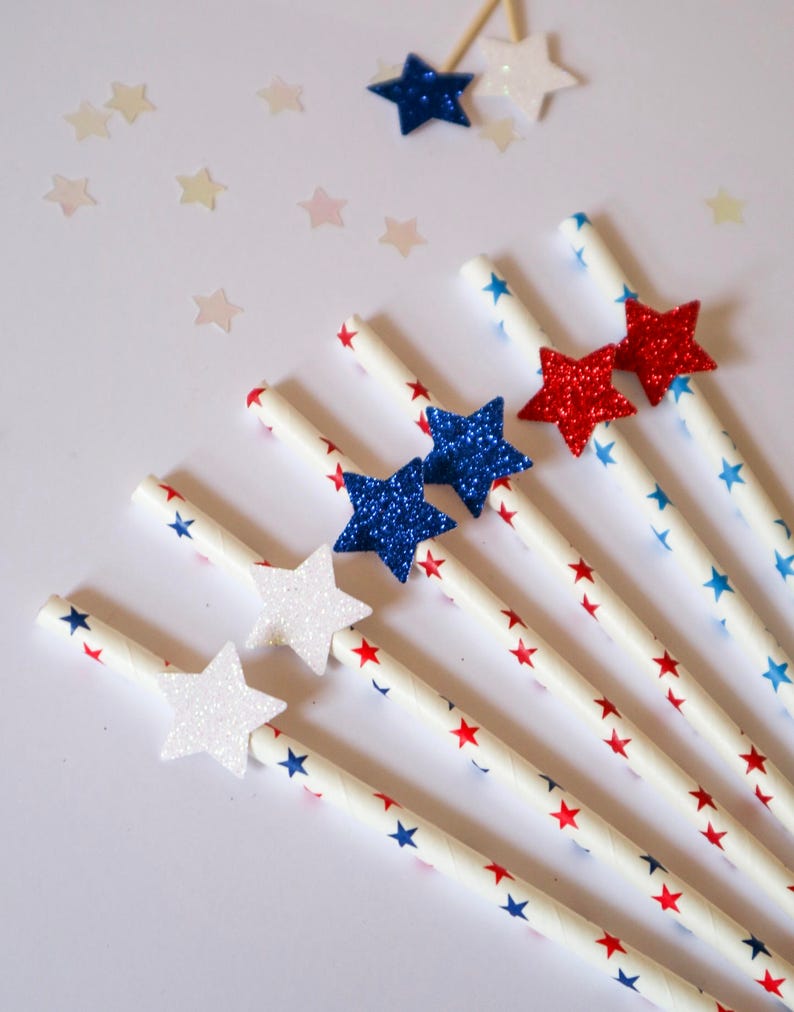 May include: Set of six red, white, and blue paper straws with glitter stars. The straws are decorated with red and blue stars on a white background.