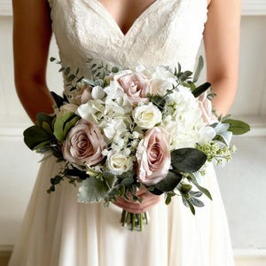 Blush pink and white silk flowers. Roses, peonies and gypsophila bridal bouquet.