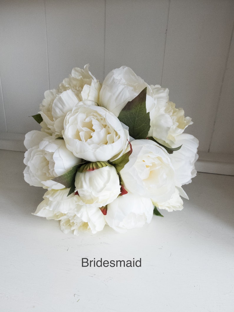 Ivory and cream peony wedding bouquet with greenery.