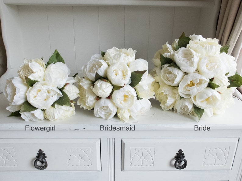 Ivory and cream peony wedding bouquet with greenery.
