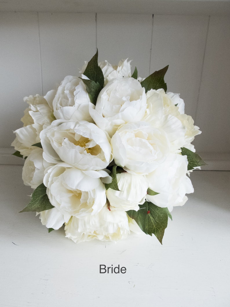Ivory and cream peony wedding bouquet with greenery.