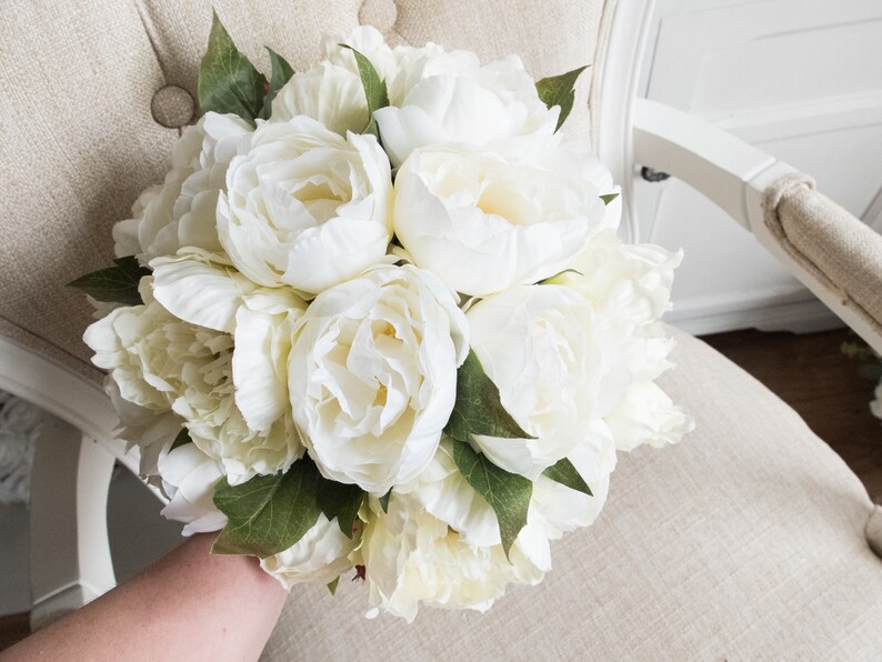 Ivory and cream peony wedding bouquet with greenery.