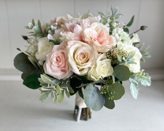 Elegant ivory, pale peach and light pink silk wedding flowers.