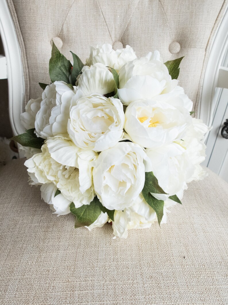 Ivory and cream peony wedding bouquet with greenery.