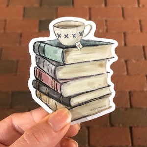 May include: A stack of vintage books with a small teacup on top. The teacup has a blue and white pattern and a small red heart tag. The books are stacked on a white background with the text "Hope's Palette" on the bottom book.