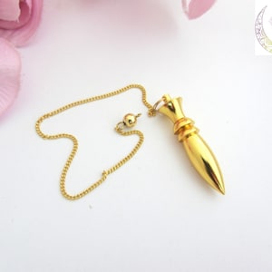 Golden metal pendulum, divination