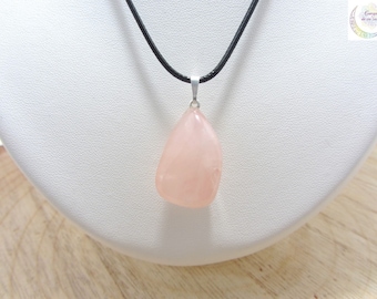 May include: A pink rose quartz pendant on a black leather cord. The pendant is a natural, freeform shape.