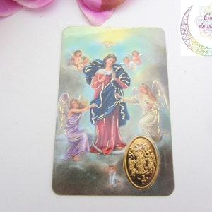 Peut inclure: Une carte rectangulaire avec une illustration religieuse. L'image représente une femme en robe rouge et bleue entourée d'anges. Un emblème ovale doré est en bas. La carte porte le texte "Energie de vie sacrée".
