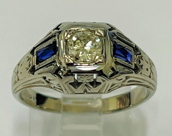 Ladies solitaire type ring set with round brilliant cut center stone diamond, appr.  .50carat H-SI1 quality &  sapphire gemstones
