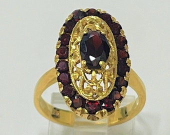 Ladies filigree oval shape cocktail ring set with natural garnet gemstones in 18k yellow gold
