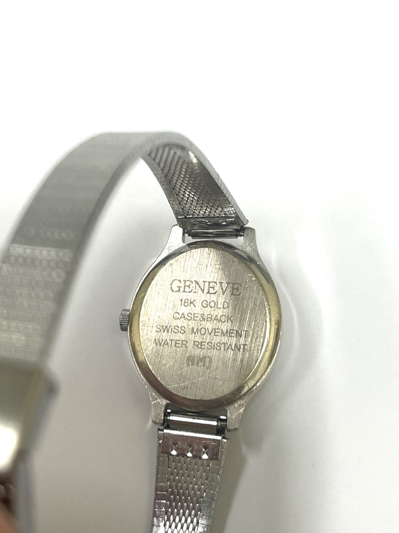 Ladies vintage 18K white gold Geneve oval shaped quartz movement watch set with round diamonds and mesh type stainless steel band. image 5