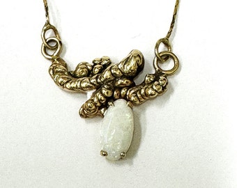 Ladies' vintage 14kt yellow gold custom made pendant with 10x6mm oval shaped opal gemstone.