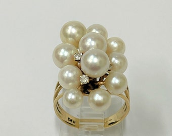 Ladies pearl and diamond ring set with 11 round saltwater natural pearls varying from 7 to 4mm and 4 brilliant cut diamonds