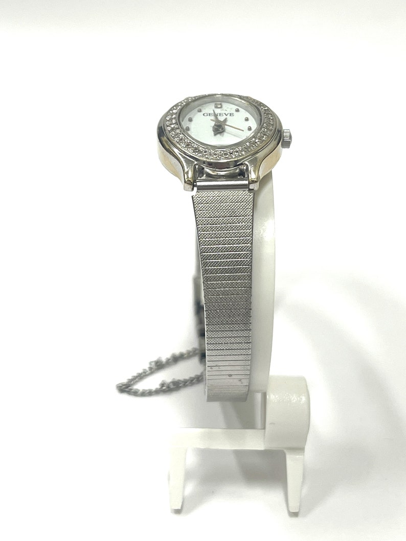 Ladies vintage 18K white gold Geneve oval shaped quartz movement watch set with round diamonds and mesh type stainless steel band. image 2