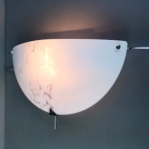 Murano hand-worked art glass and metal frame 1980s crescent-shaped wall lamp. One of four.