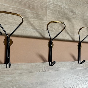 Vintage 1950s wall coat rack, Mid-Century Modern with brass & black-lacquered metal hooks, upholstered panel