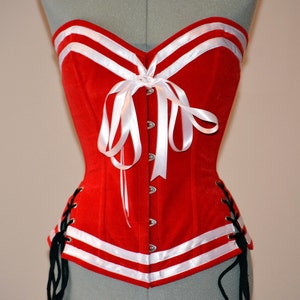 Pinup authentic red corset with bows and laces on hips. Steel-boned corset for tight lacing. Prom, burlesque, cosplay, cute red corset.