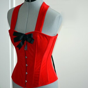 Cute pinup red microfibra (fake suede) custom made corset with bow. Steel-boned overbust corset top for tight lacing with strap around neck.