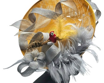Large gold chic fascinator with birds in nest gray yellow with gray red styled dress. derby hat kentucky paddocks.perfect with mint julep.